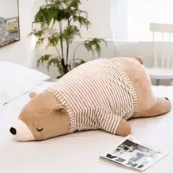Peluche ours marron habillé qui dort